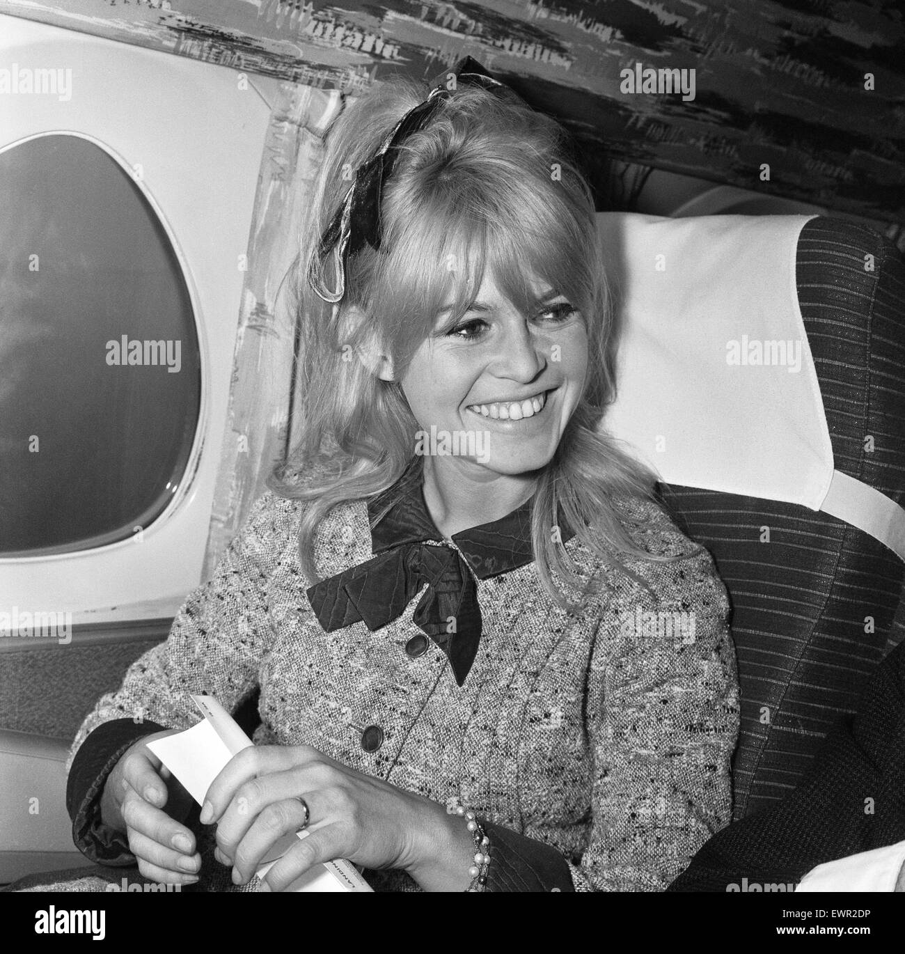 Brigitte Bardot, french film actress, flies in from Orly Airport Paris, to complete scenes on her new film, The Adorable Idiot, in London, pictured arriving at London Heathrow Airport and on aircraft, being interviewed by The Daily Mirror's Donald Zec, 23 Stock Photo