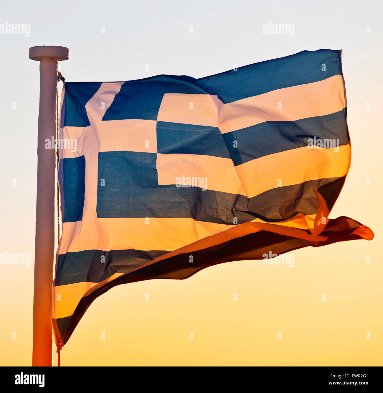 greek flag at sunset in santorini Stock Photo