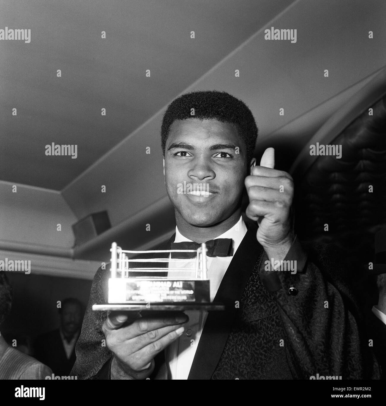 Cassius Clay (Muhammad Ali) holding up a miniature boxing ring which was presented to him in Soho London. 19th May 1966 Stock Photo