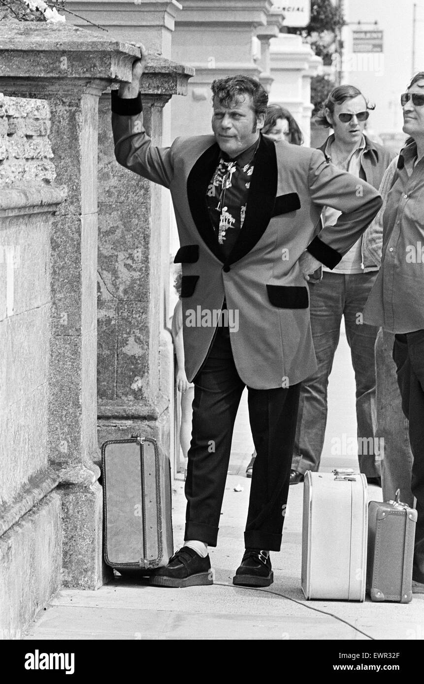 Actor Oliver Reed dressed in Teddy Boy clothing during a break in filming of the pop opera 'Tommy' by director Ken Russell. 13th June 1974. Stock Photo