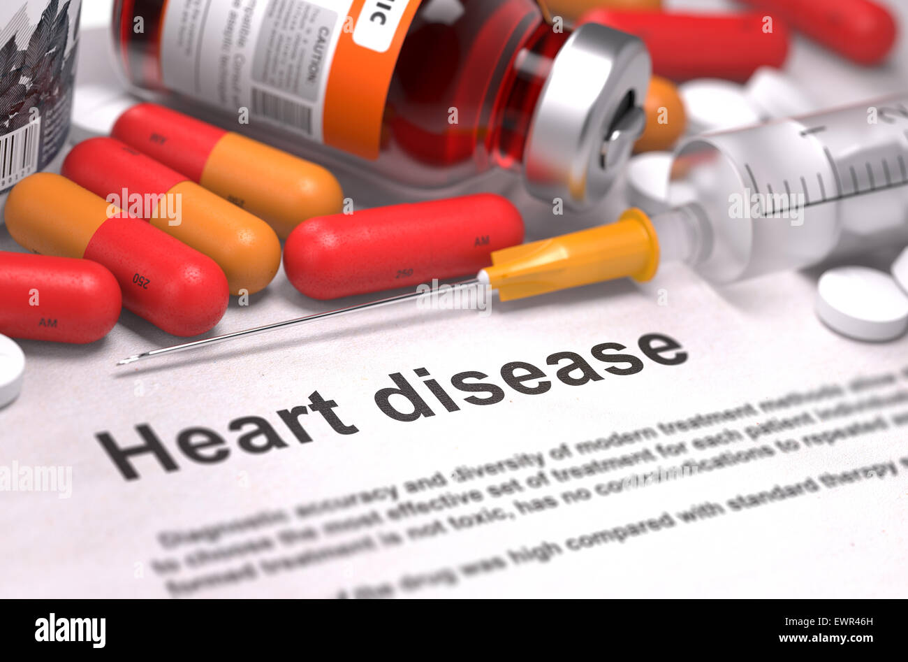Heart disease - Printed Diagnosis with Blurred Text. On Background of Medicaments Composition - Red Pills, Injections and Syring Stock Photo