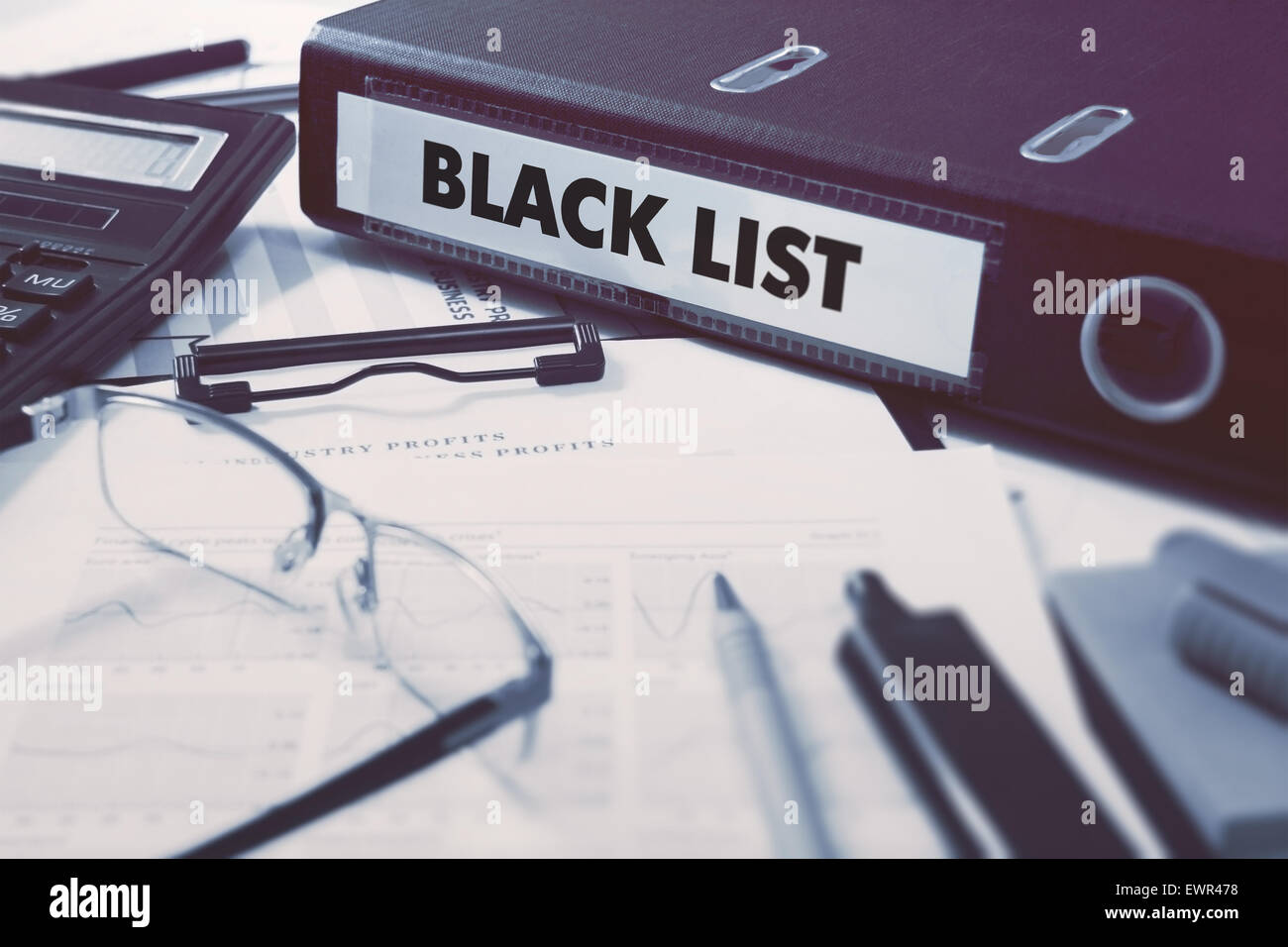 Office folder with inscription Black List on Office Desktop with Office Supplies. Business Concept on Blurred Background. Toned Stock Photo
