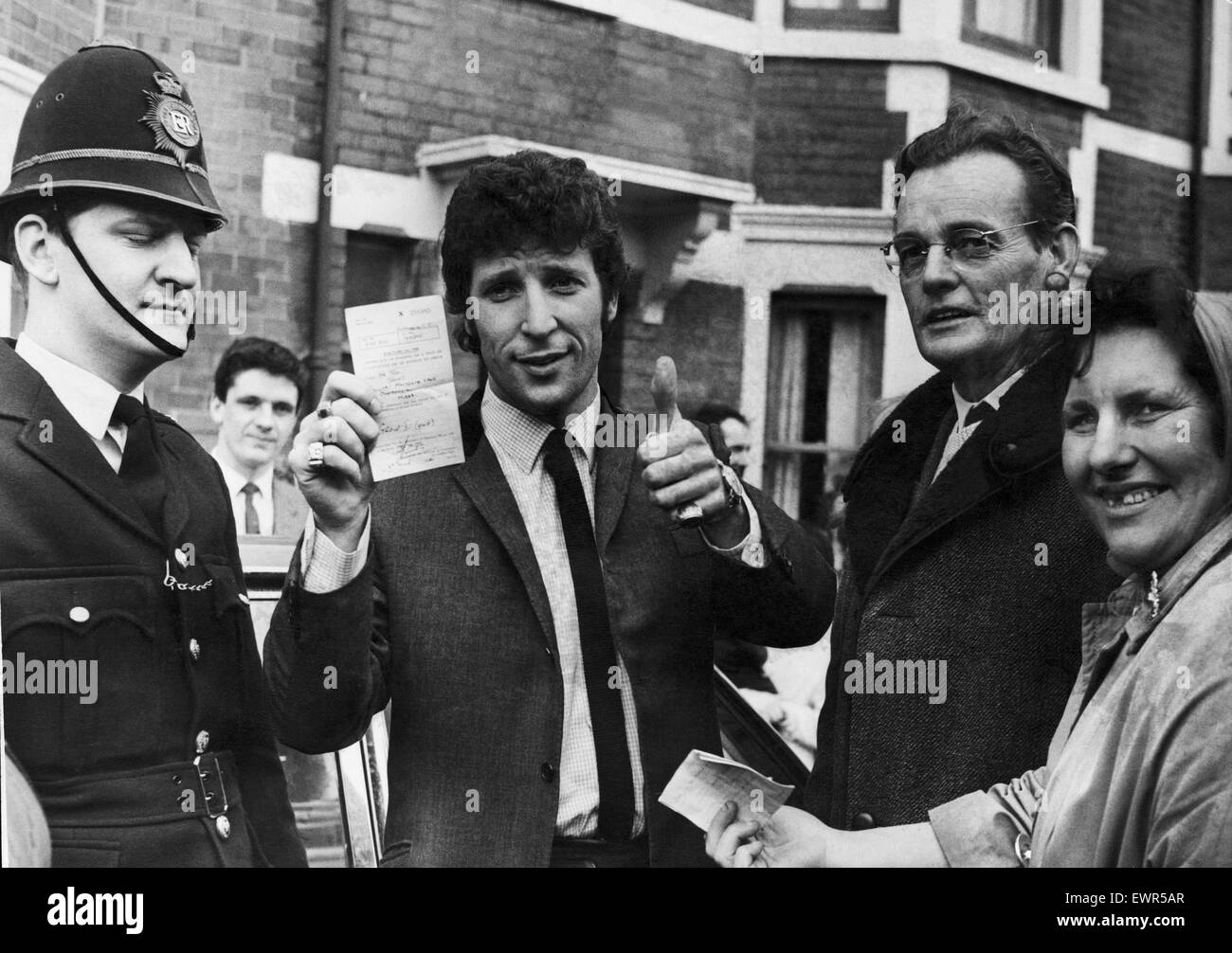 Welsh singing star Tom Jones shows his certificate after passing his driving test in Newport today. March 1966 Stock Photo