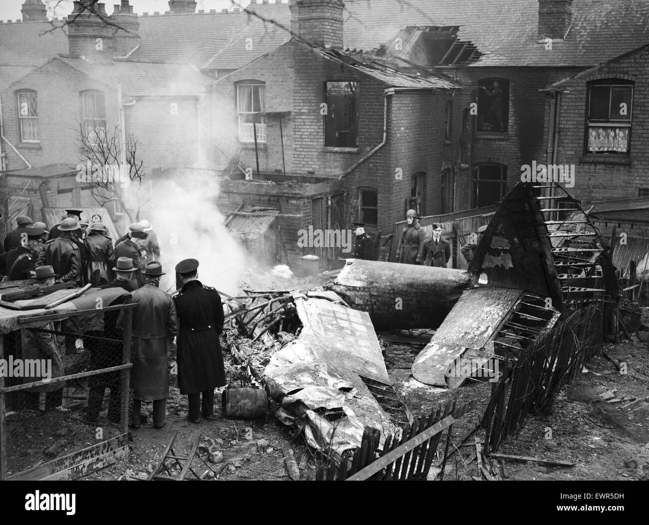 Site of a downed Bristol Blenheim in Bearwood, Birmingham during the Second World War showing emergency services at the scene in a residential street after it collided with a barrage balloon cable. 20th February 1942. Stock Photo