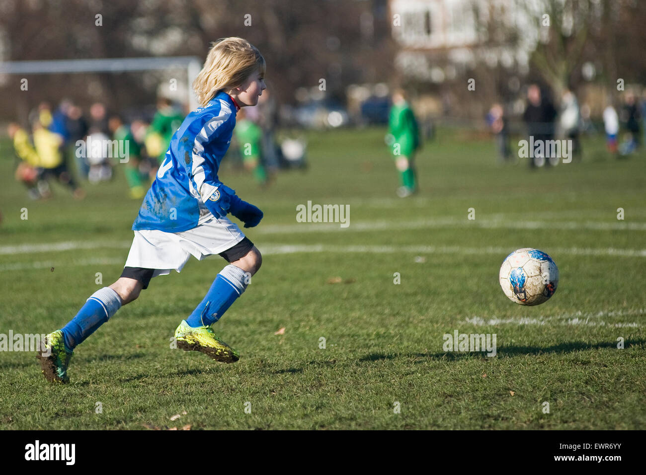 A young boy plays football in London for his local team Stock Photo Alamy
