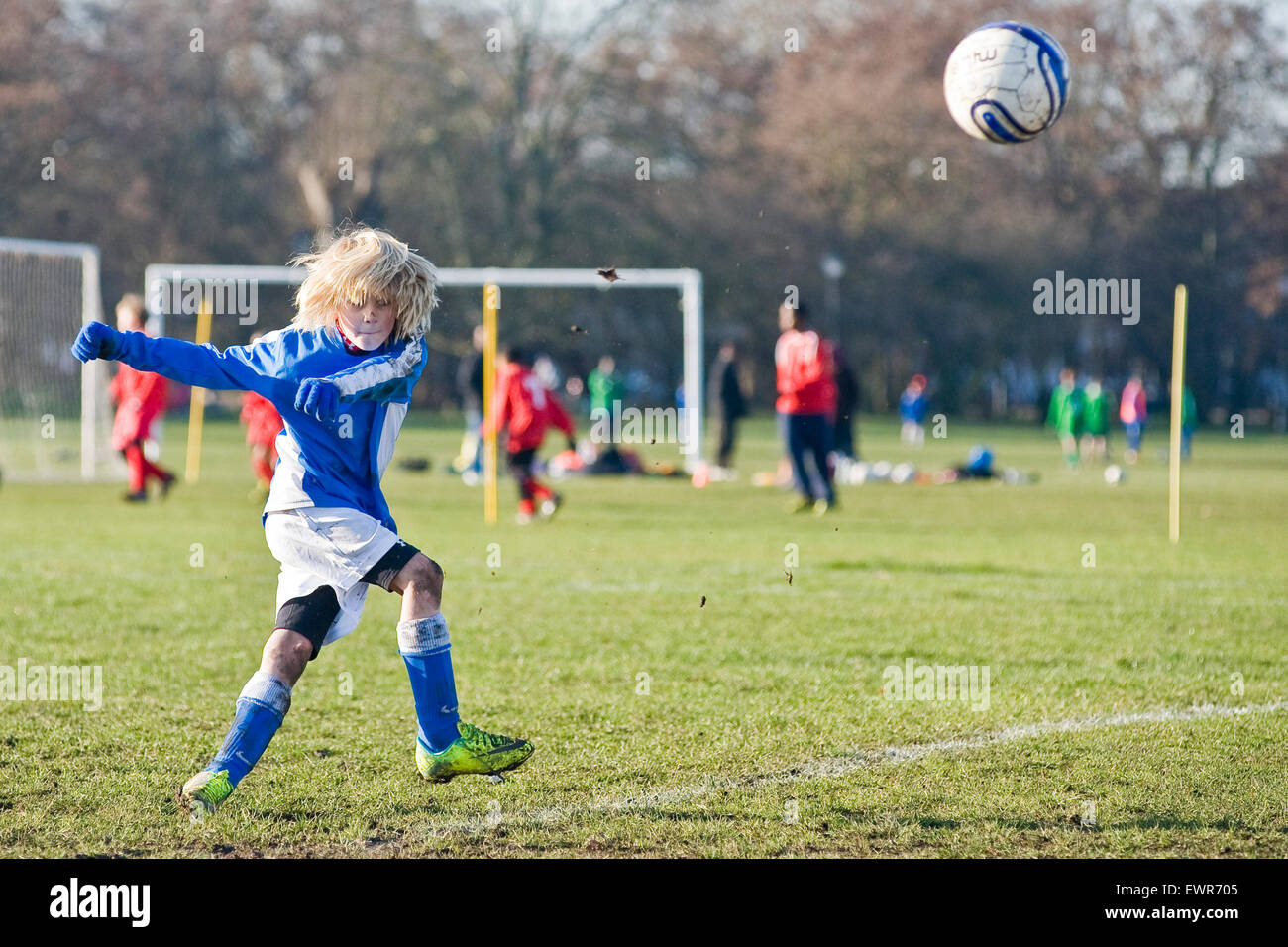 A young boy plays football in London for his local team Stock Photo Alamy