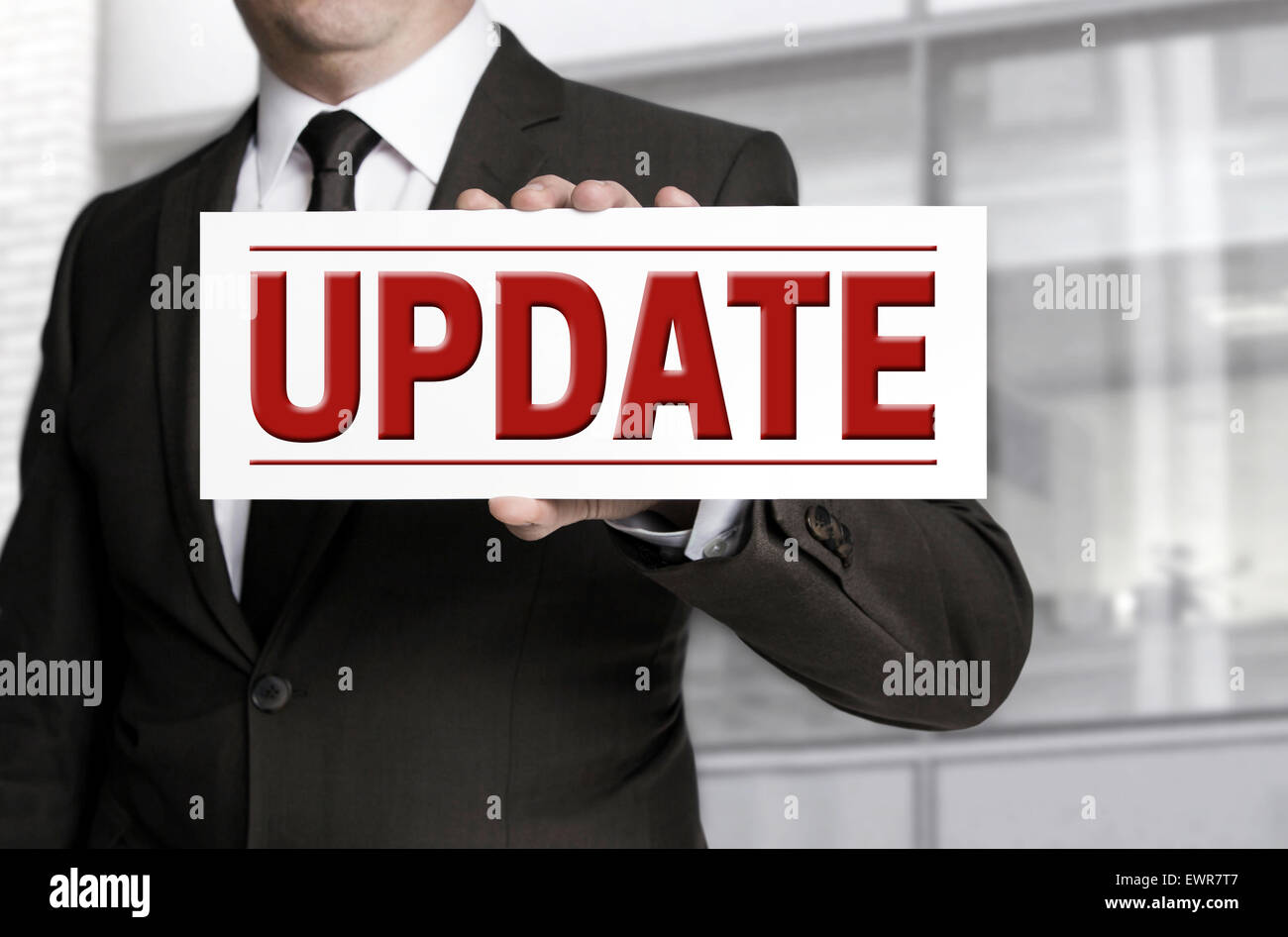 Update sign is held by businessman. Stock Photo
