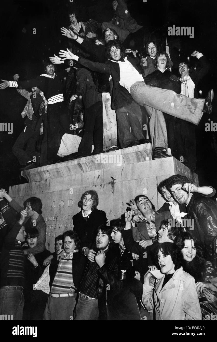 New Year revellers besiege the statue of Lady Godiva during the celebrations to see in 1977. 1st January 1977 Stock Photo