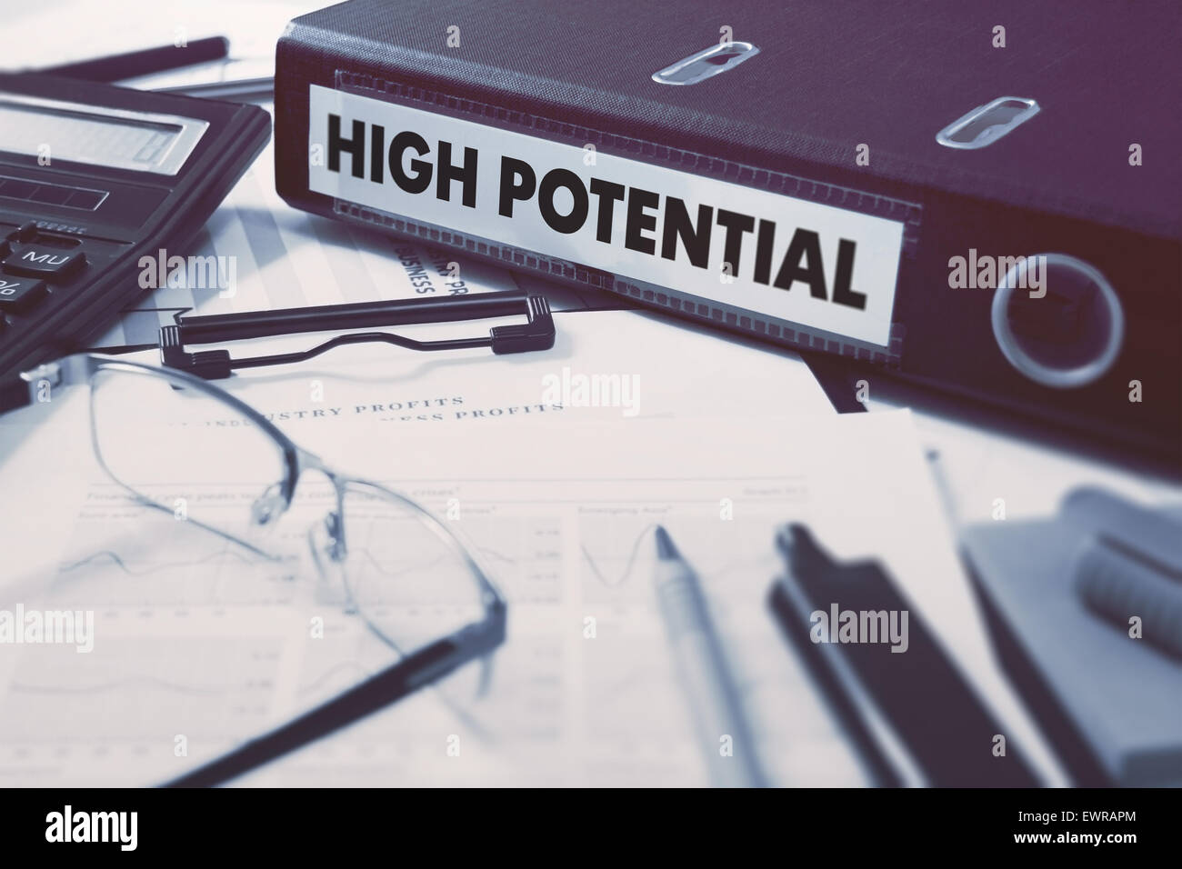 High Potential - Ring Binder on Office Desktop with Office Supplies. Business Concept on Blurred Background. Toned Illustration. Stock Photo