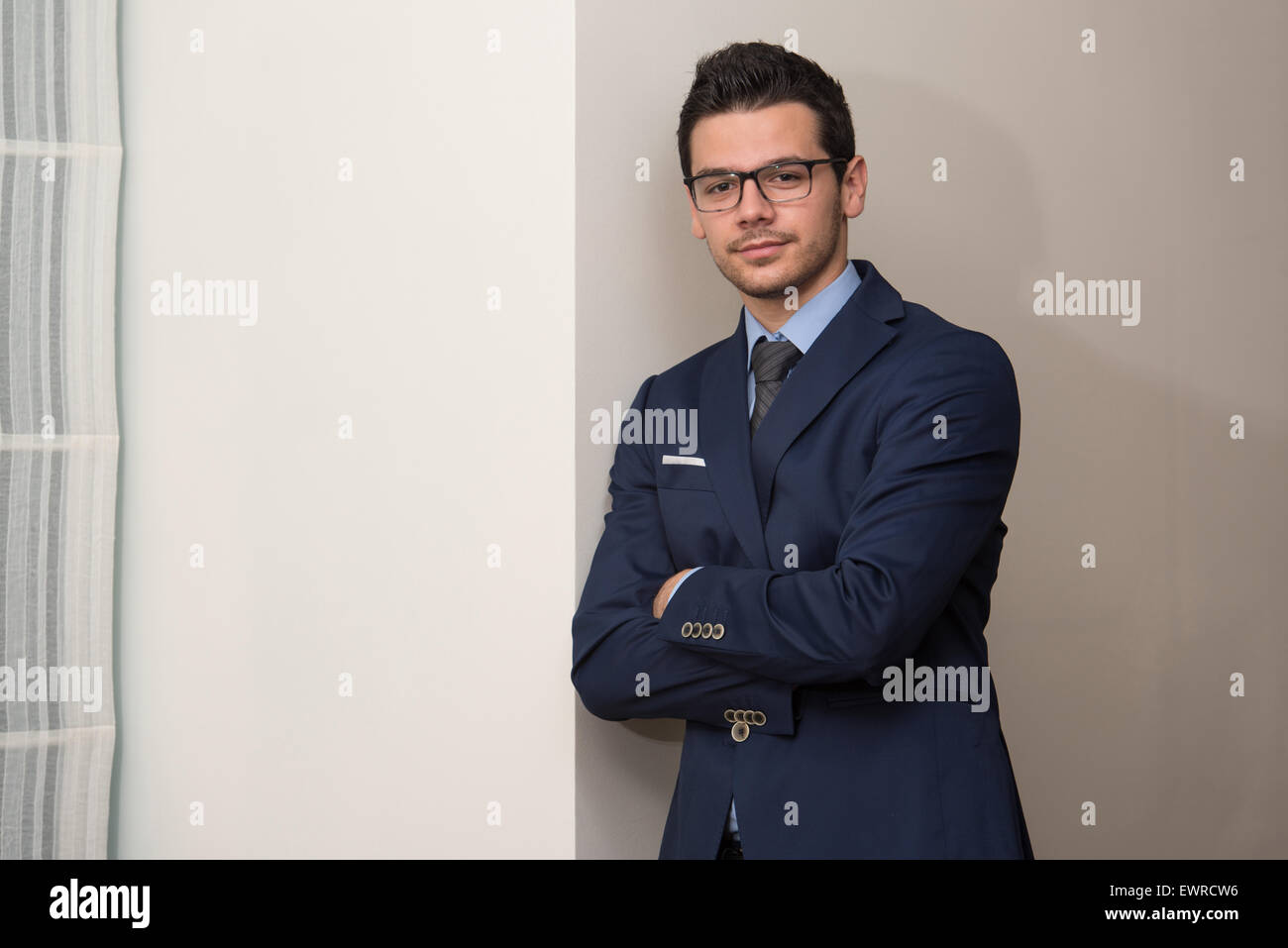 Portrait Of Handsome Confident Young Businessman Standing Arms Crossed ...