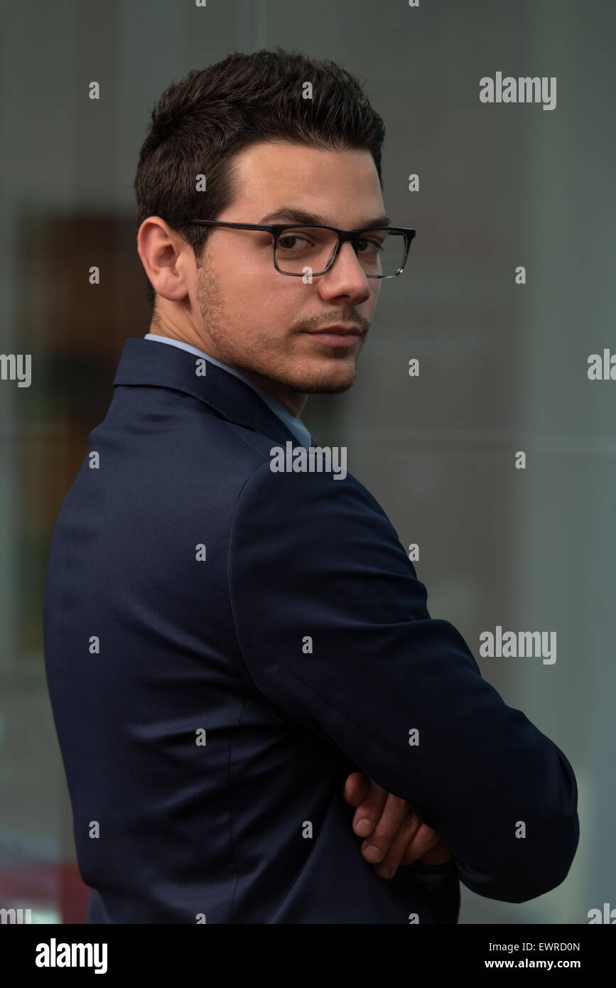 Portrait Of Handsome Confident Young Businessman Standing Arms Crossed ...