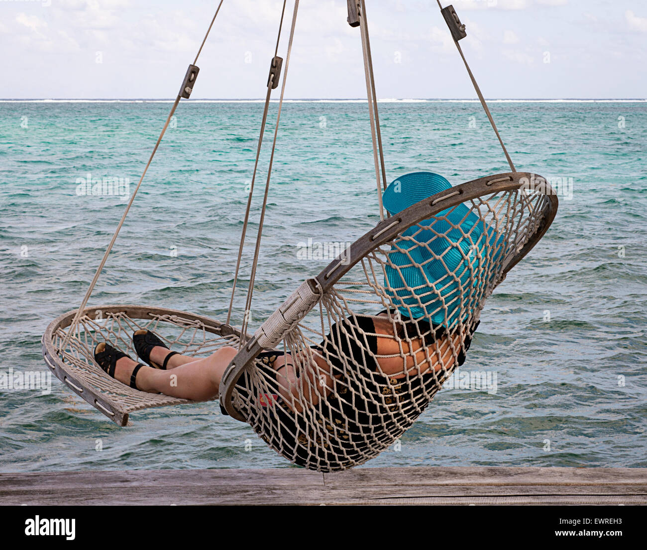 Woman relaxing in hanging chair hi-res stock photography and images - Alamy