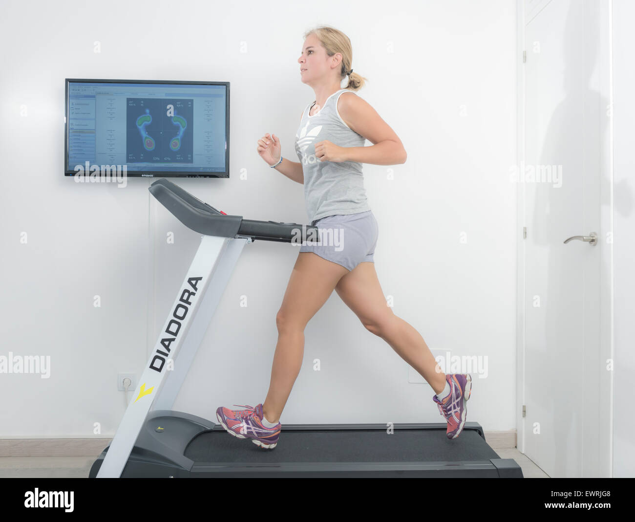 Woman on a running machine Stock Photo - Alamy