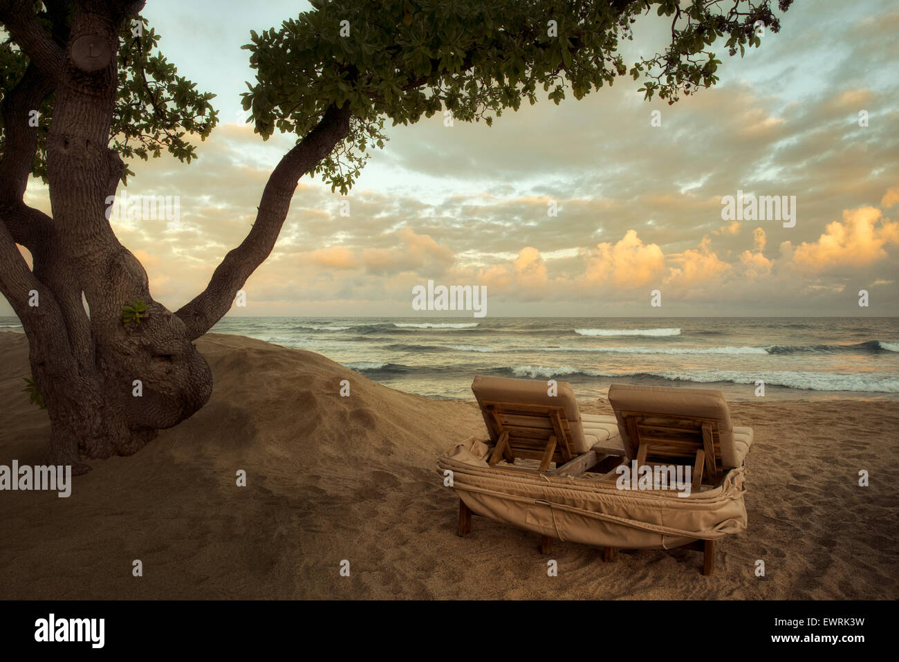 Sunrise and waves with beach chairs. Hawaii, The big Island. Stock Photo