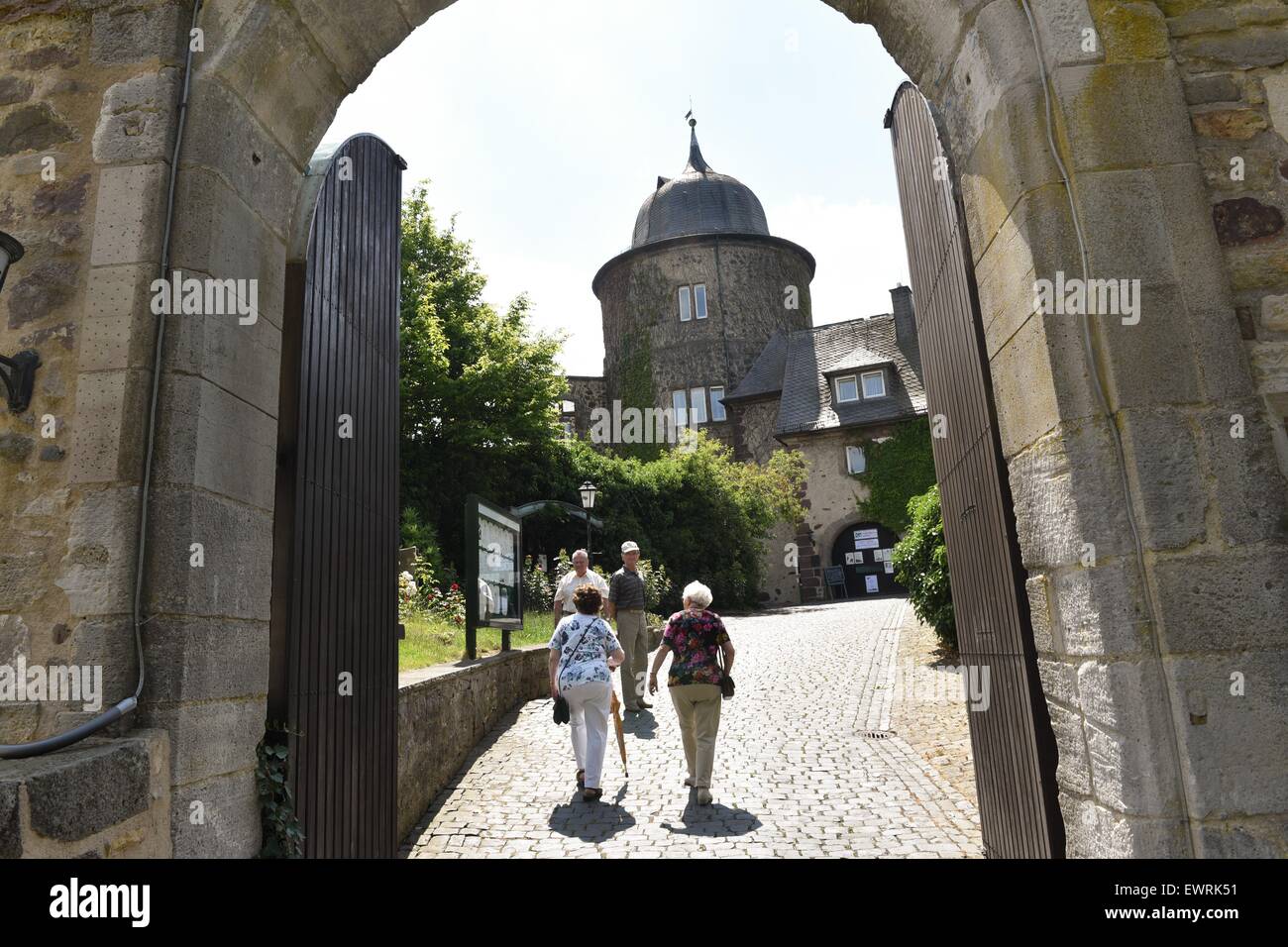 Hofgeismar, Germany. 30th June, 2015. Tourists walk through the archway of the Dornroeschenschloss Sababurg (lit. Sleeping Beauty's Castle) near Hofgeismar, Germany, 30 June 2015. Due to restoration work the castle will be closed for two years from 2016. Photo: UWE ZUCCHI/dpa/Alamy Live News Stock Photo