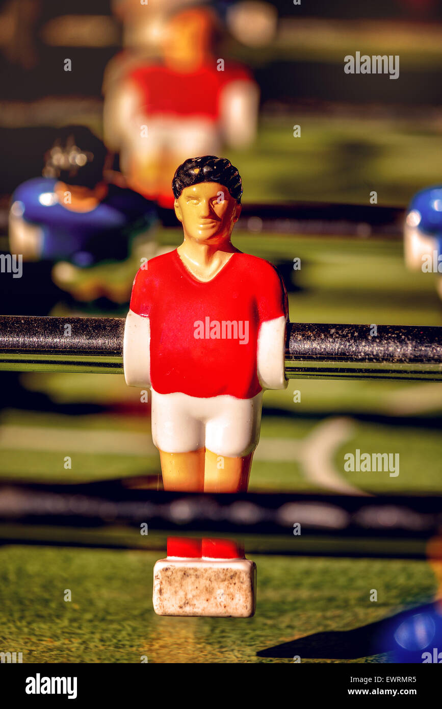 Single Player in Red Jersey, Vintage Foosball, Table Soccer or Football Kicker Game, Selective Focus, Retro Tone Effect Stock Photo