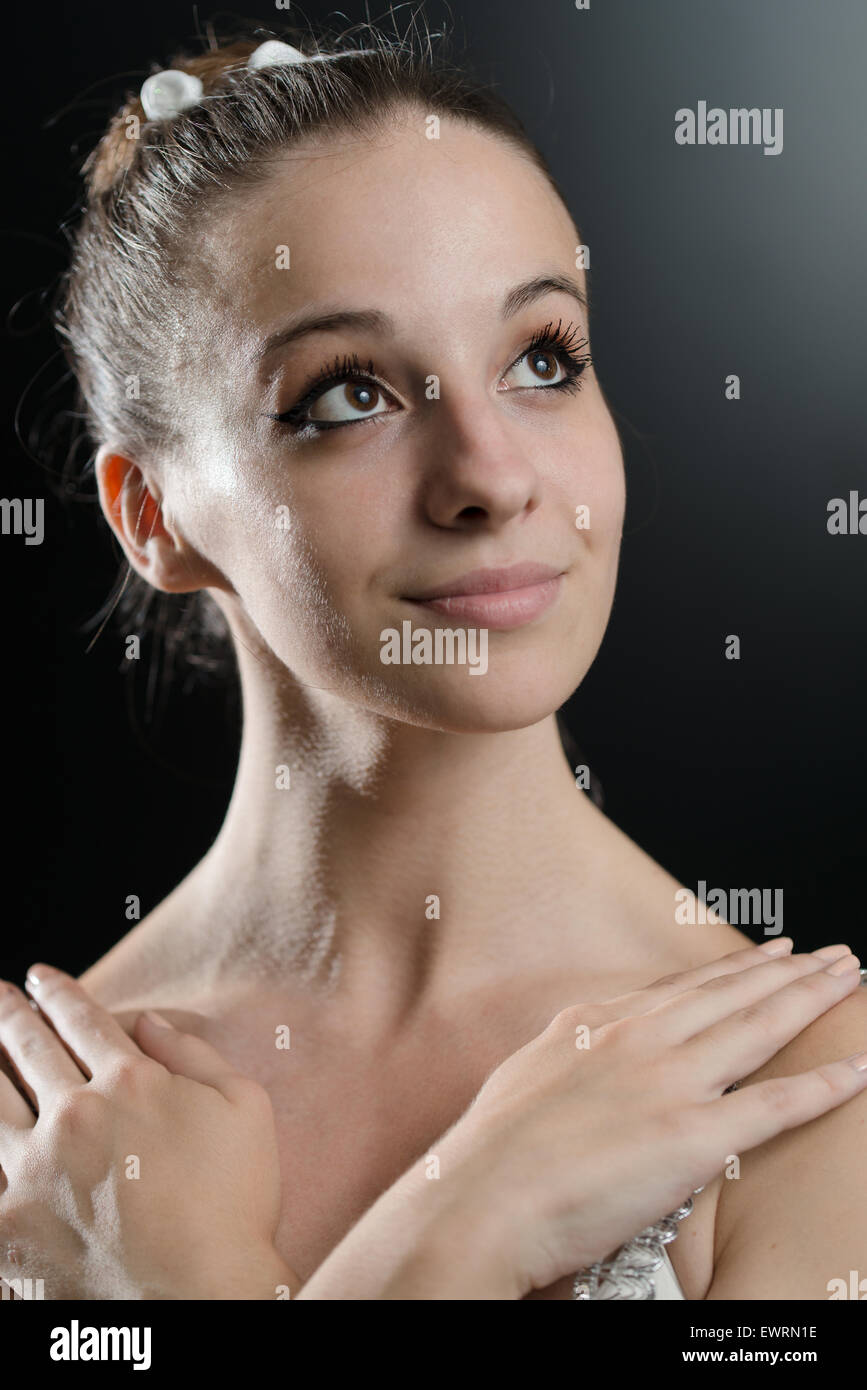 Close Up Of A Beautiful Female Ballet Dancer On A Black Background