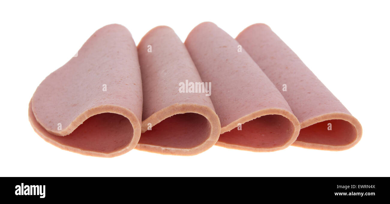 Four slices of bologna folded in half on a white background Stock Photo