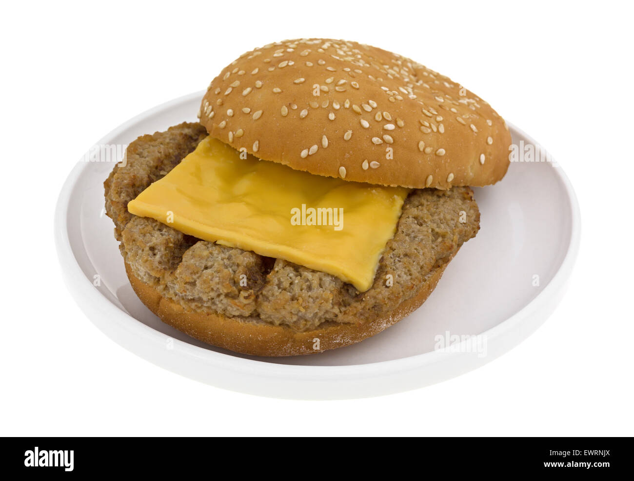 A microwaved cheeseburger on a small plate atop a white background. Stock Photo