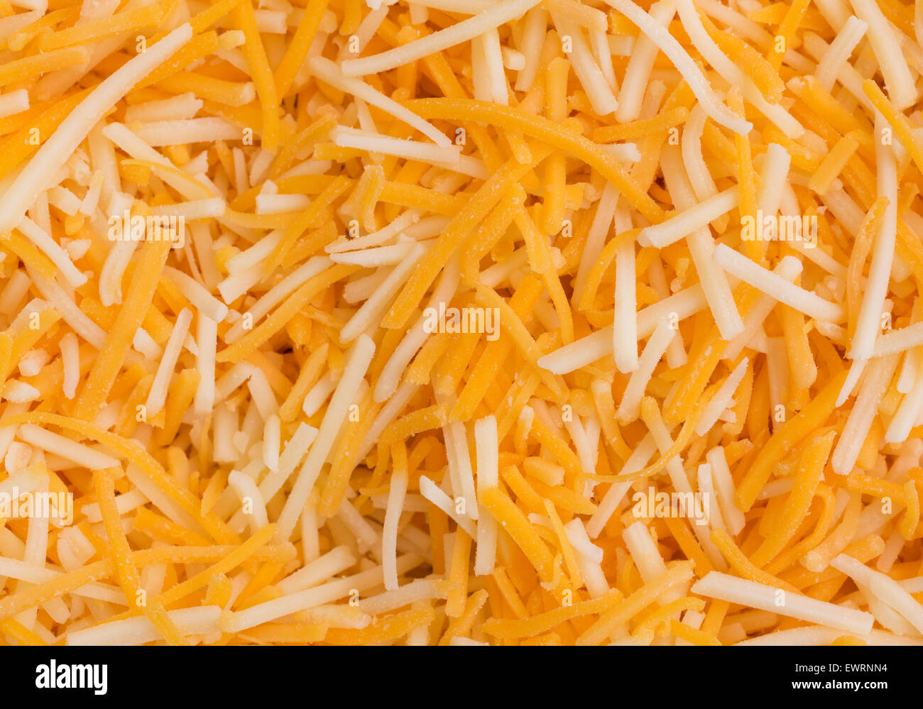 Close view of a shredded white cheddar, sharp cheddar and mild cheddar cheeses. Stock Photo