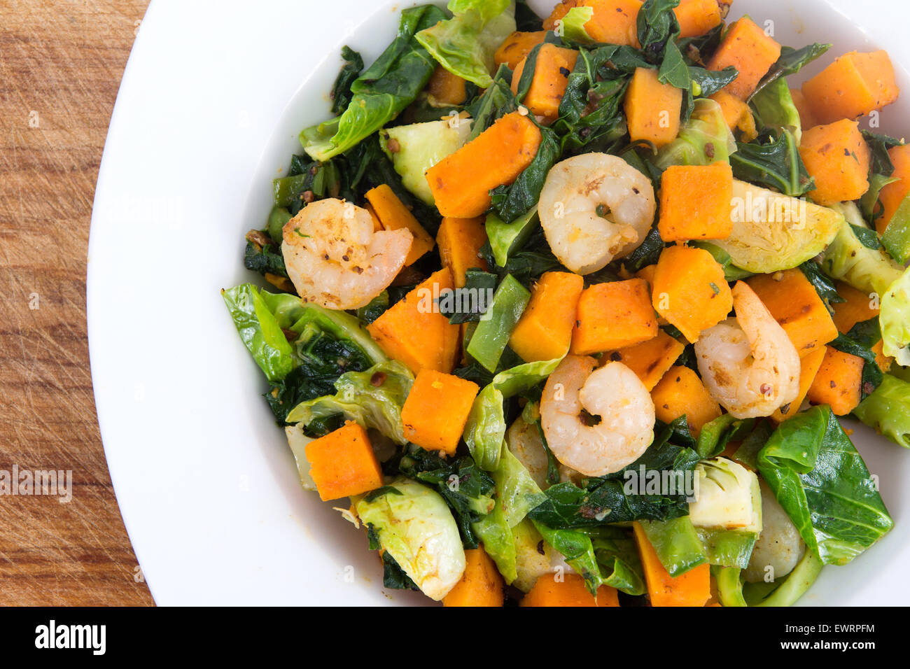 Sweet potato casserole with greens and shrimps Stock Photo