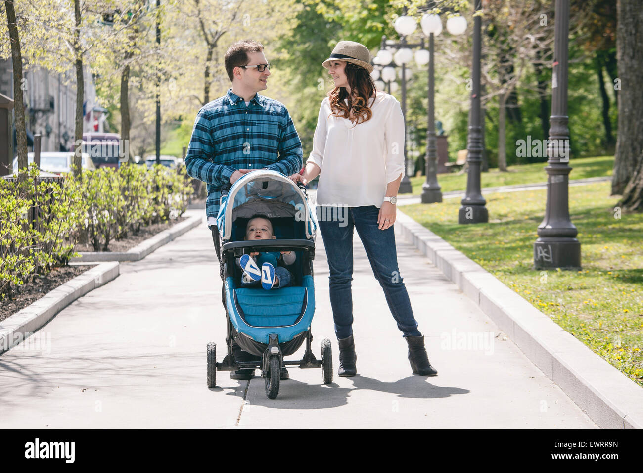 young family with baby strollers on city walk Stock Photo - Alamy