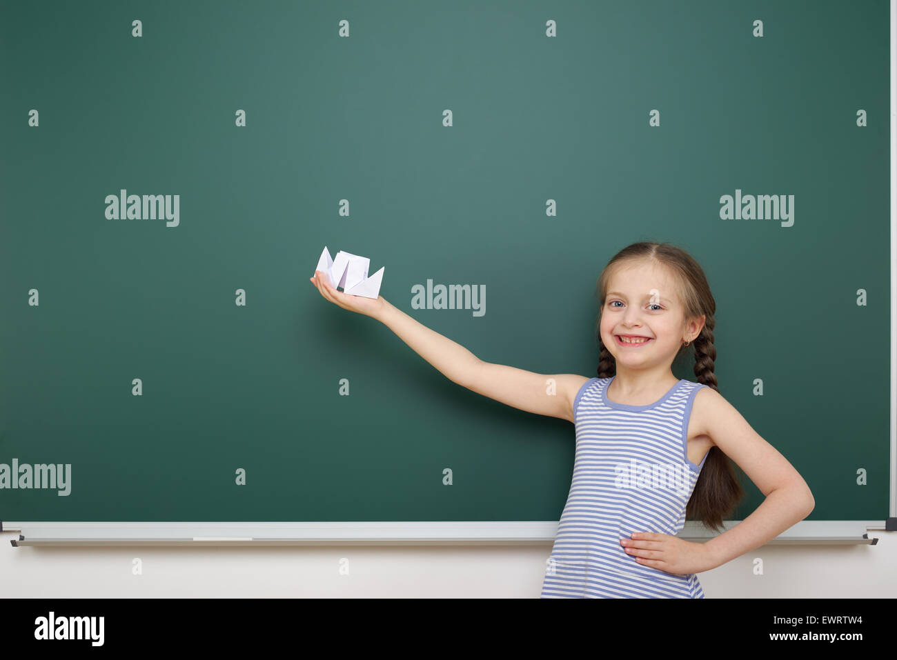 Schoolgirl near the school board Stock Photo - Alamy