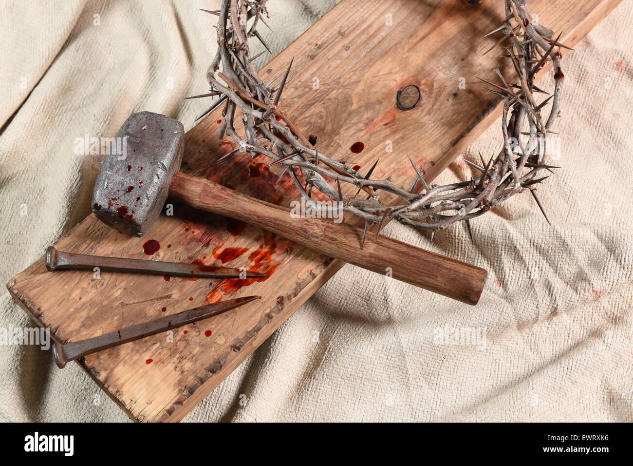 Crown of thorns, nails, and mallet over vintage cloth Stock Photo