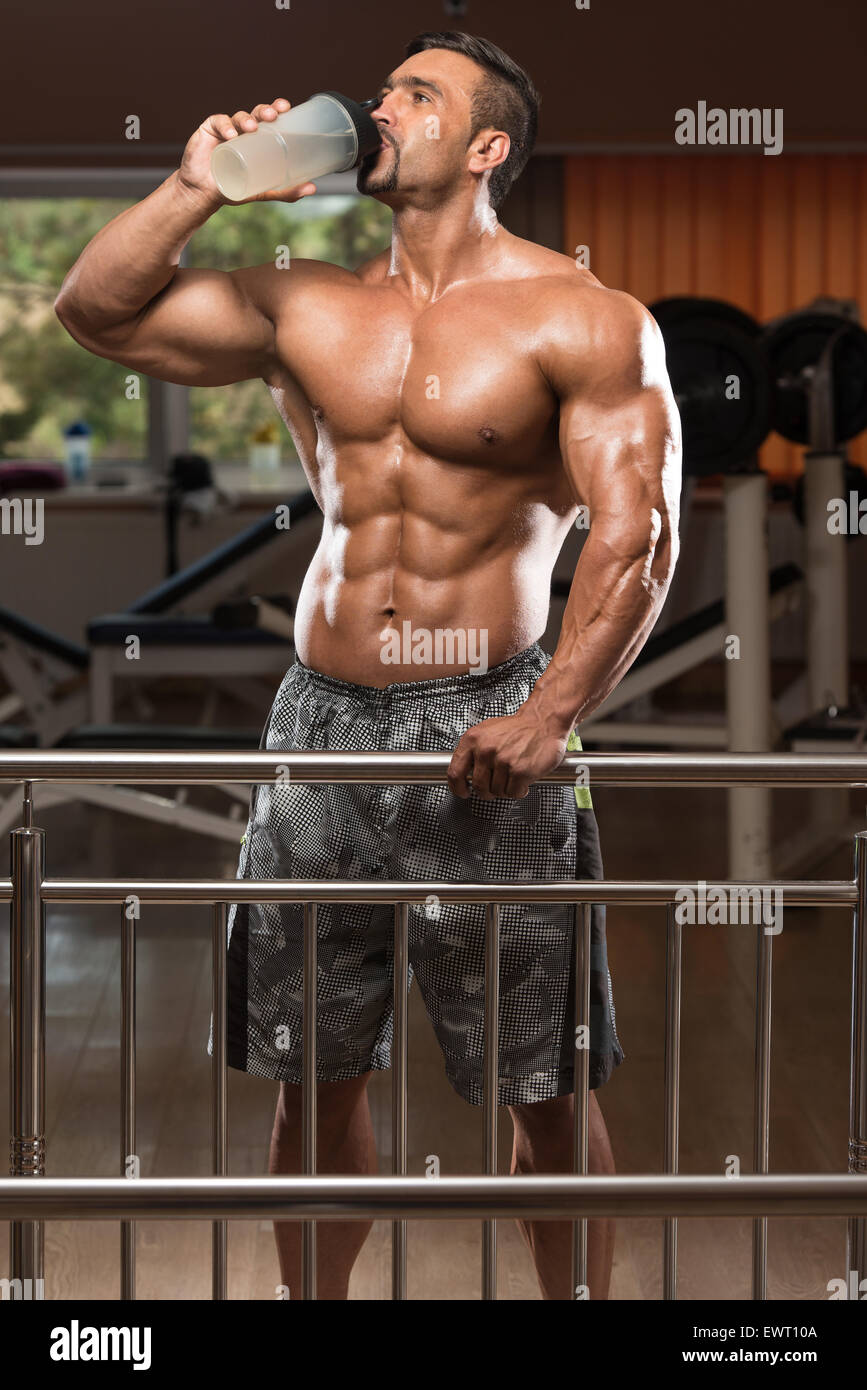 Muscular Man Drinking A Water Bottle Stock Photo - Alamy