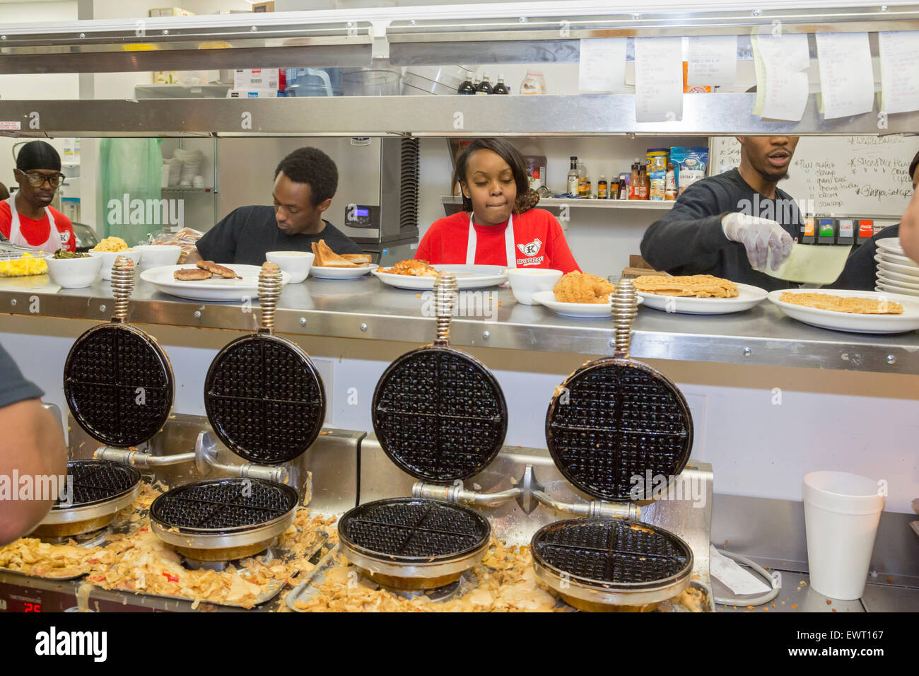 Detroit, Michigan - Servers pick up their orders in the kitchen at Kuzzo's Chicken & Waffles. Stock Photo
