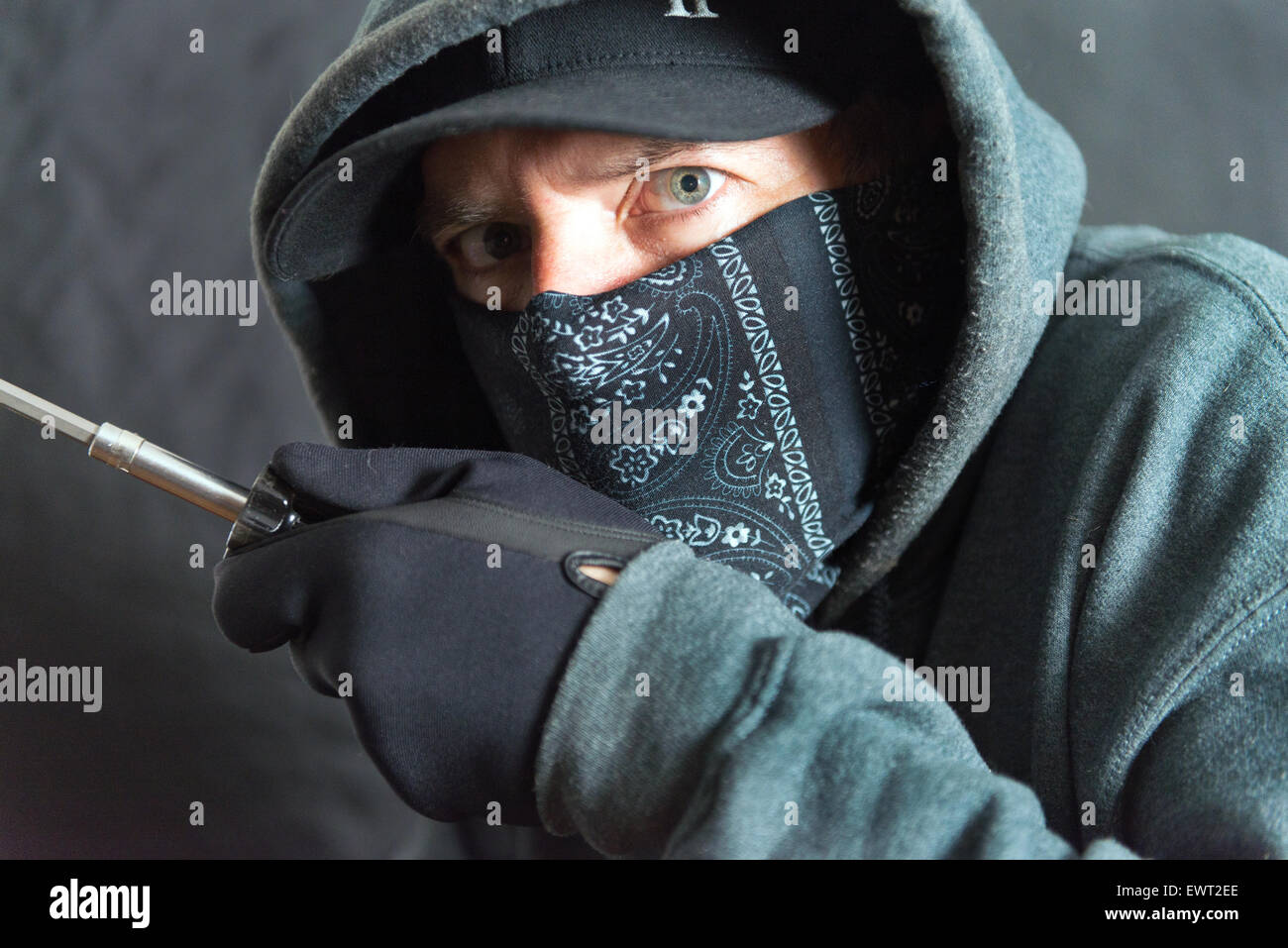 Close-up of a burglar breaking in, right side of frame Stock Photo