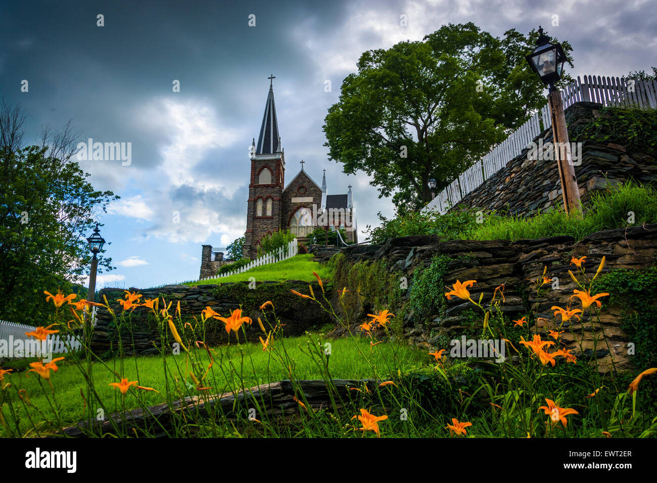 Orange lillies and St. Peters Roman Catholic Church, in Harpers Ferry, West Virginia. Stock Photo