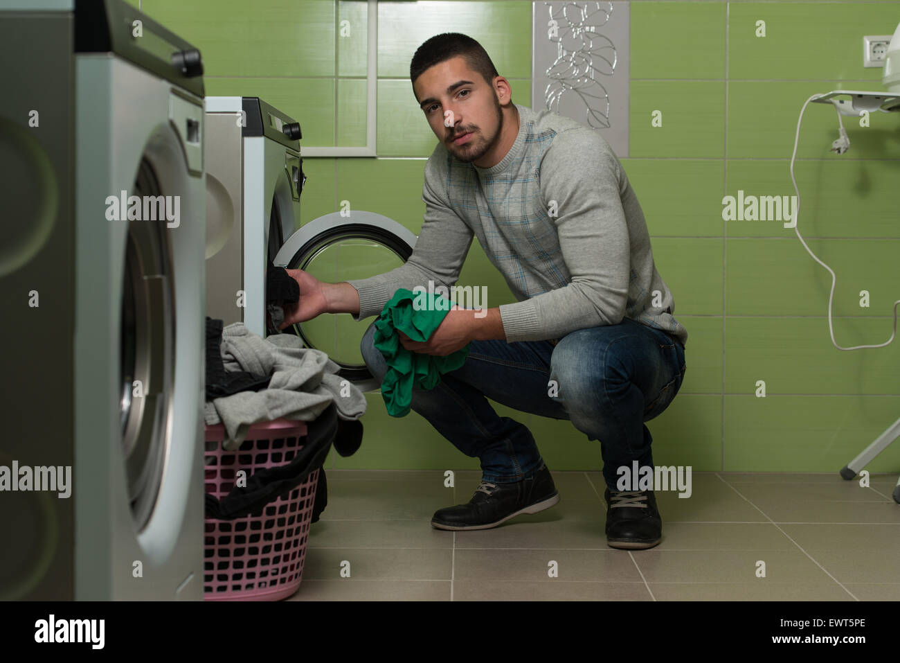 Handsome Young Man In The Laundry Room Stock Photo - Alamy