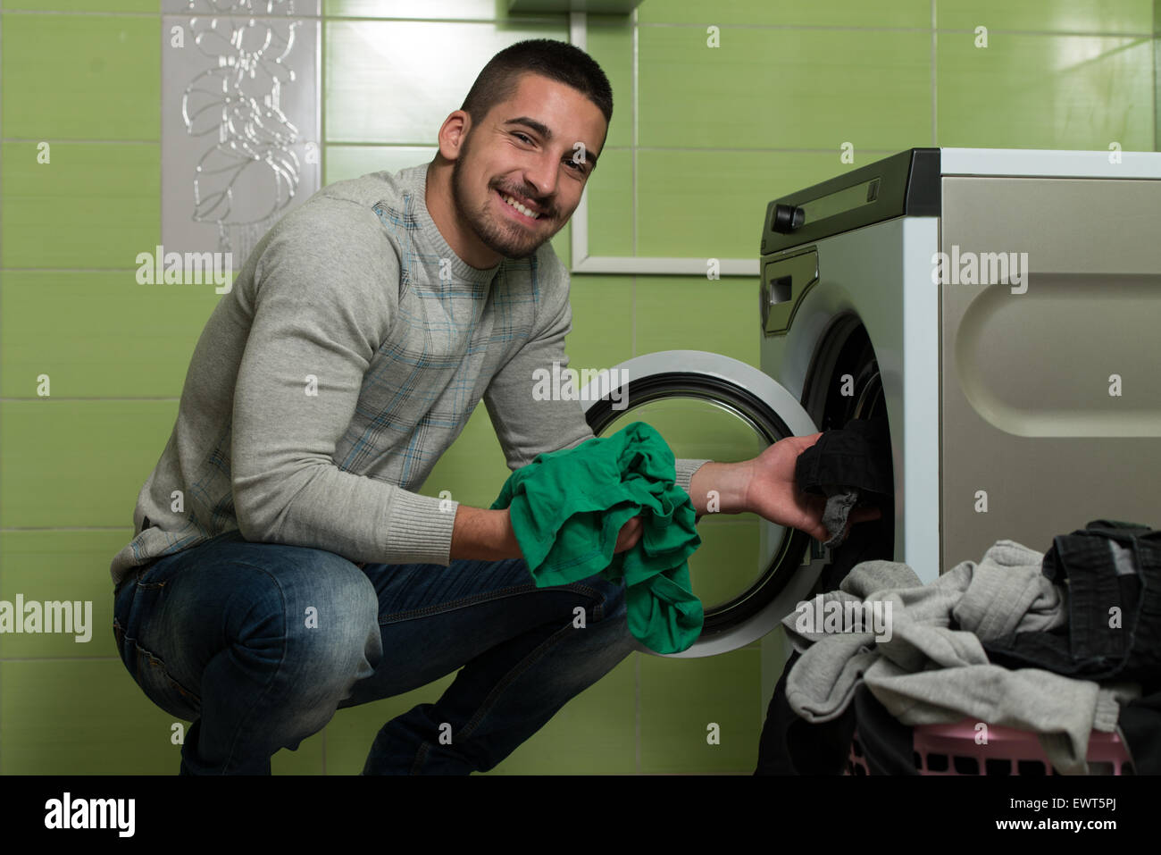 Handsome Young Man In The Laundry Room Stock Photo - Alamy