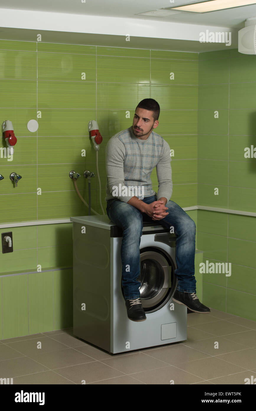 Handsome Young Man In The Laundry Room Stock Photo - Alamy