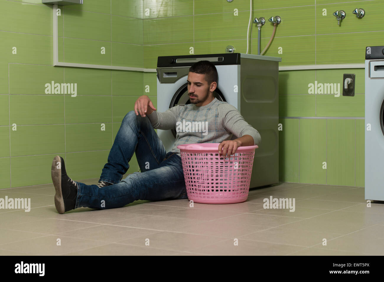 Handsome Young Man In The Laundry Room Stock Photo - Alamy