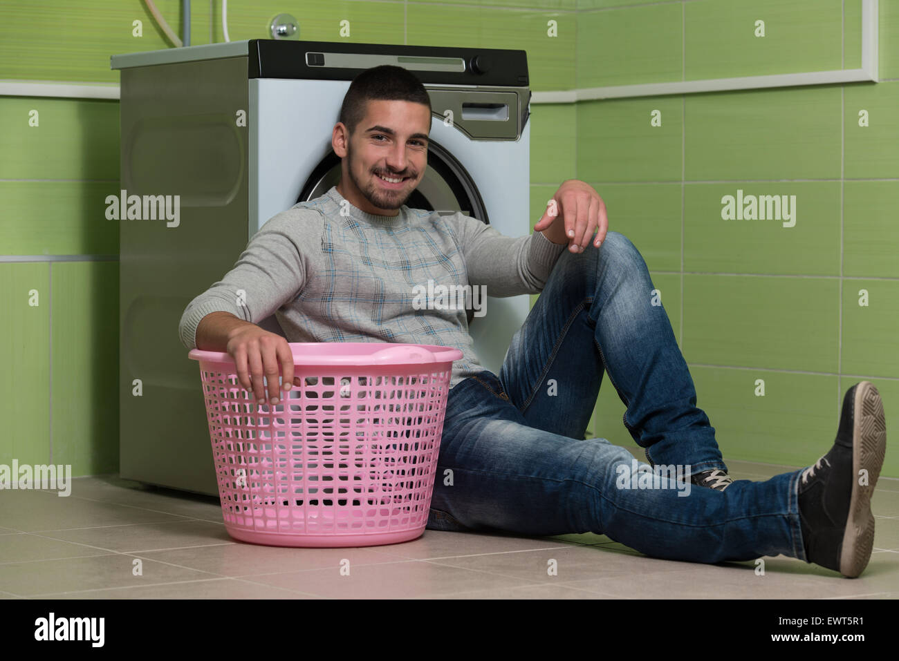 Handsome Young Man In The Laundry Room Stock Photo - Alamy