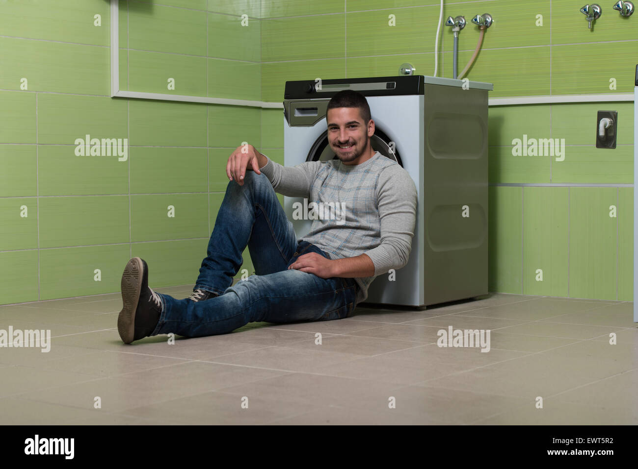 Handsome Young Man In The Laundry Room Stock Photo - Alamy