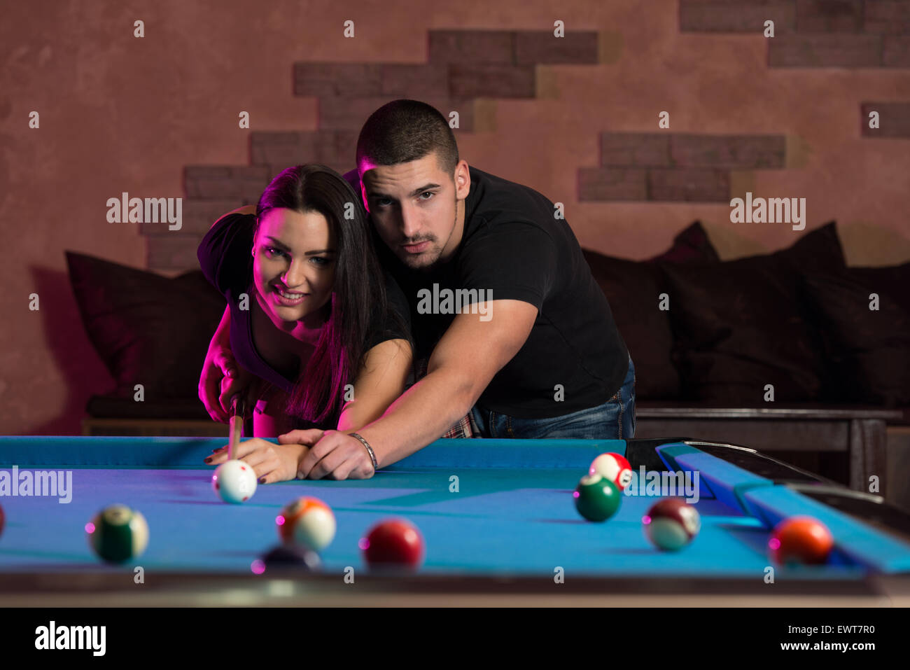 Young Caucasian Woman Receiving Advice On Shooting Pool Ball While Playing Billiards Stock Photo