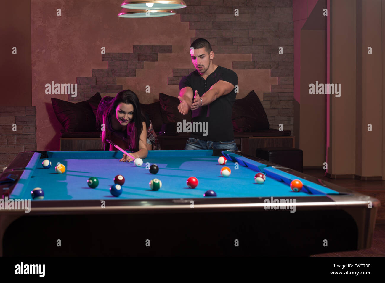 Young Caucasian Woman Receiving Advice On Shooting Pool Ball While Playing Billiards Stock Photo