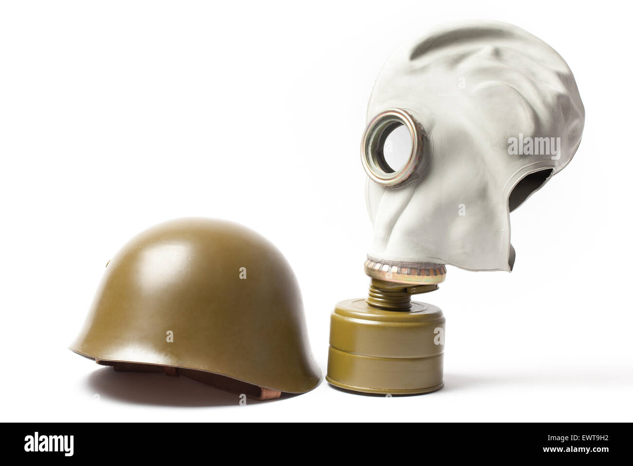 Green military helmet and an old gas mask isolated on white background. Stock Photo