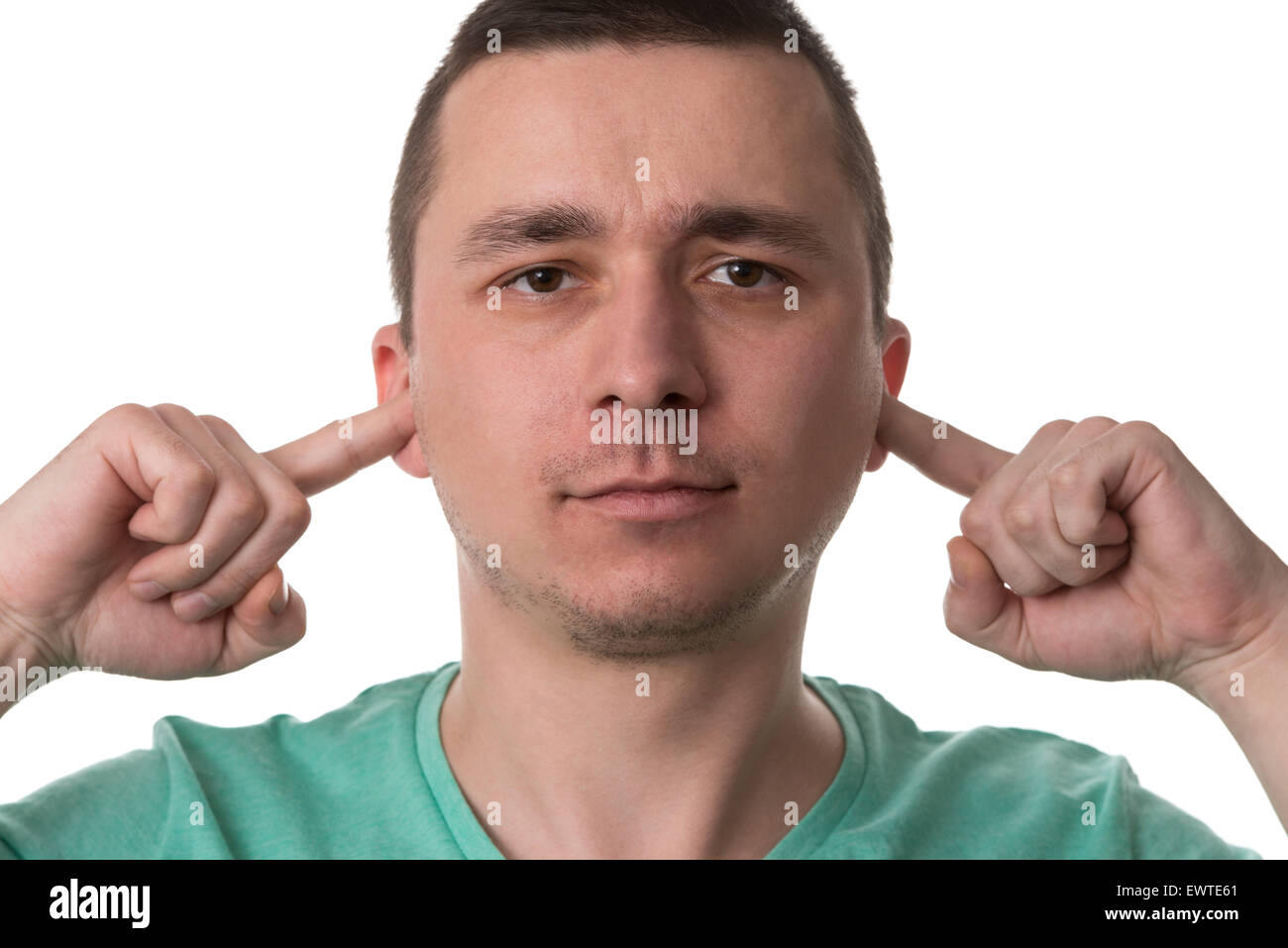Handsome Guy Closing Ears With His Fingers - Isolated On White Background Stock Photo