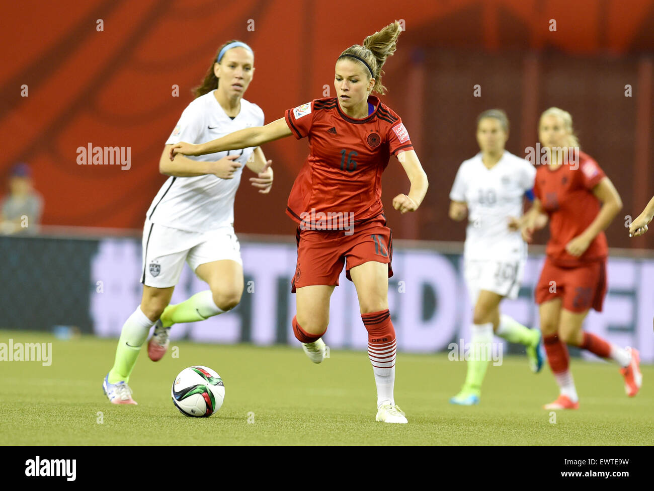 Montreal, Canada. 30th June, 2015. Germany's Melanie Leupolz (R) and Lauren Holiday of USA vie for the ball during the FIFA Women's World Cup 2015 semi final soccer match between USA and Germany at the Olympic Stadium in Montreal, Canada, 30 June 2015. Photo: Carmen Jaspersen/dpa/Alamy Live News Stock Photo