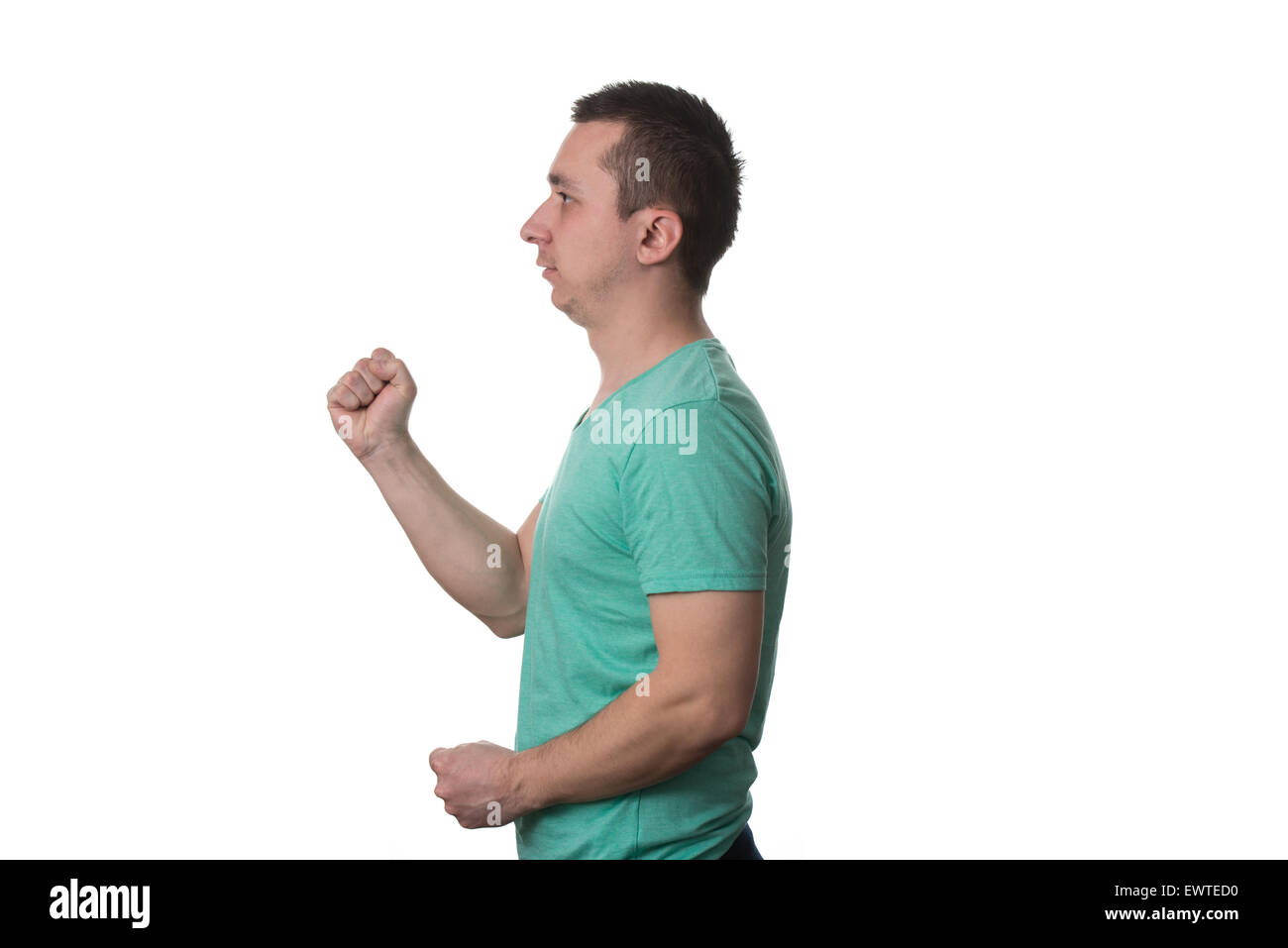 Portrait Of Angry Young Man Clenching His Fist - Isolated On White Background Stock Photo