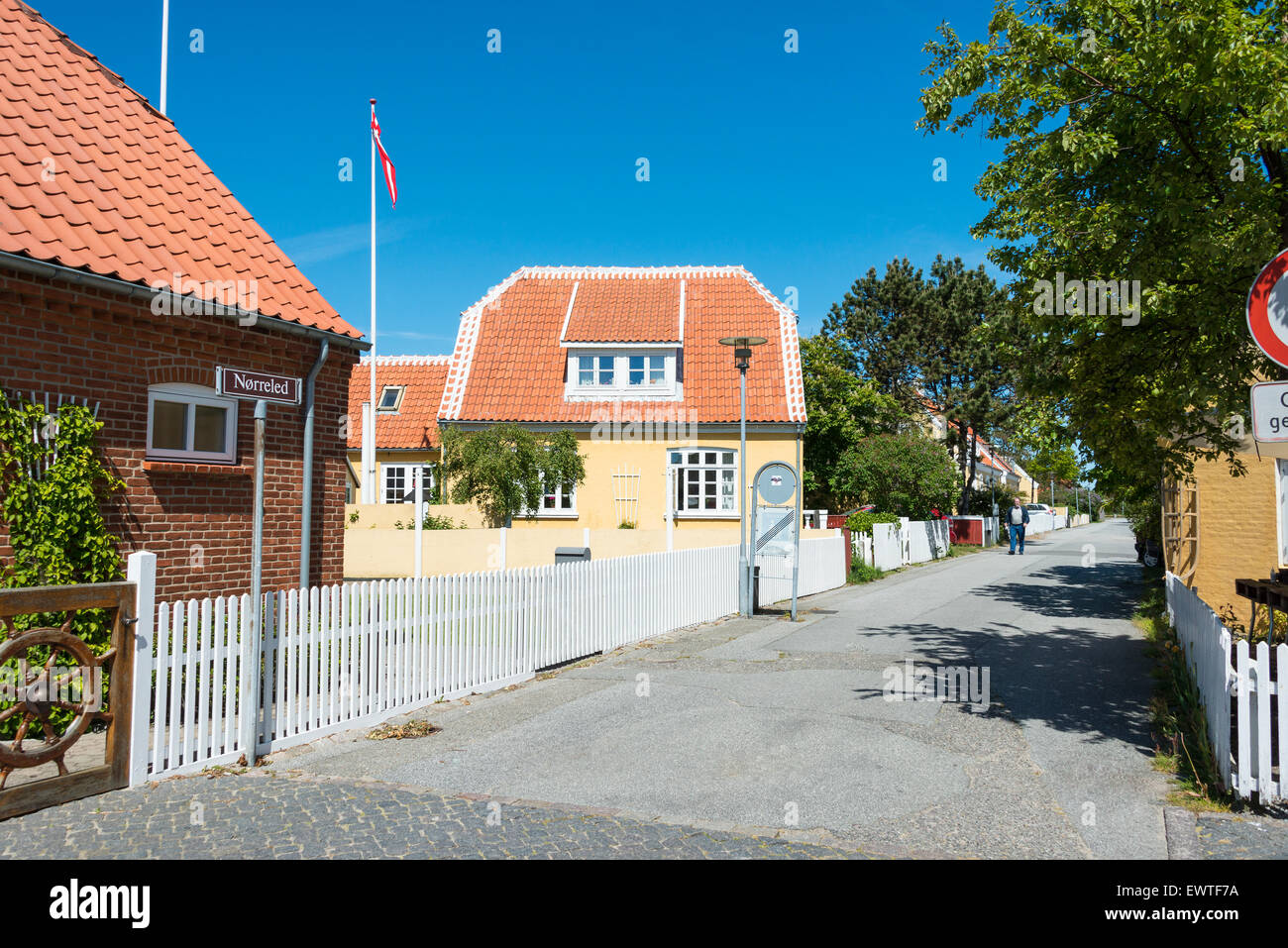 Typical Skagen street and houses with red-tiled roofs and white picket fences, Skagen, North Jutland Region, Denmark Stock Photo