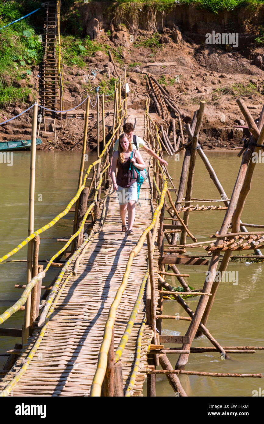 Tourists on bamboo footbridge across Nam Khan river, Luang Prabang, Laos Stock Photo