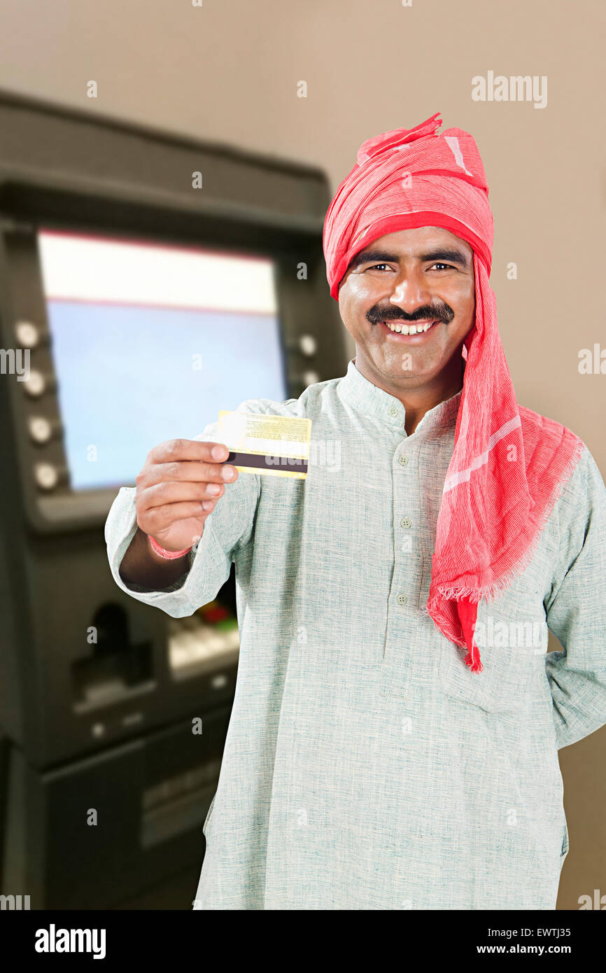 1 indain Rural man ATM Machinery Credit Card showing Stock Photo