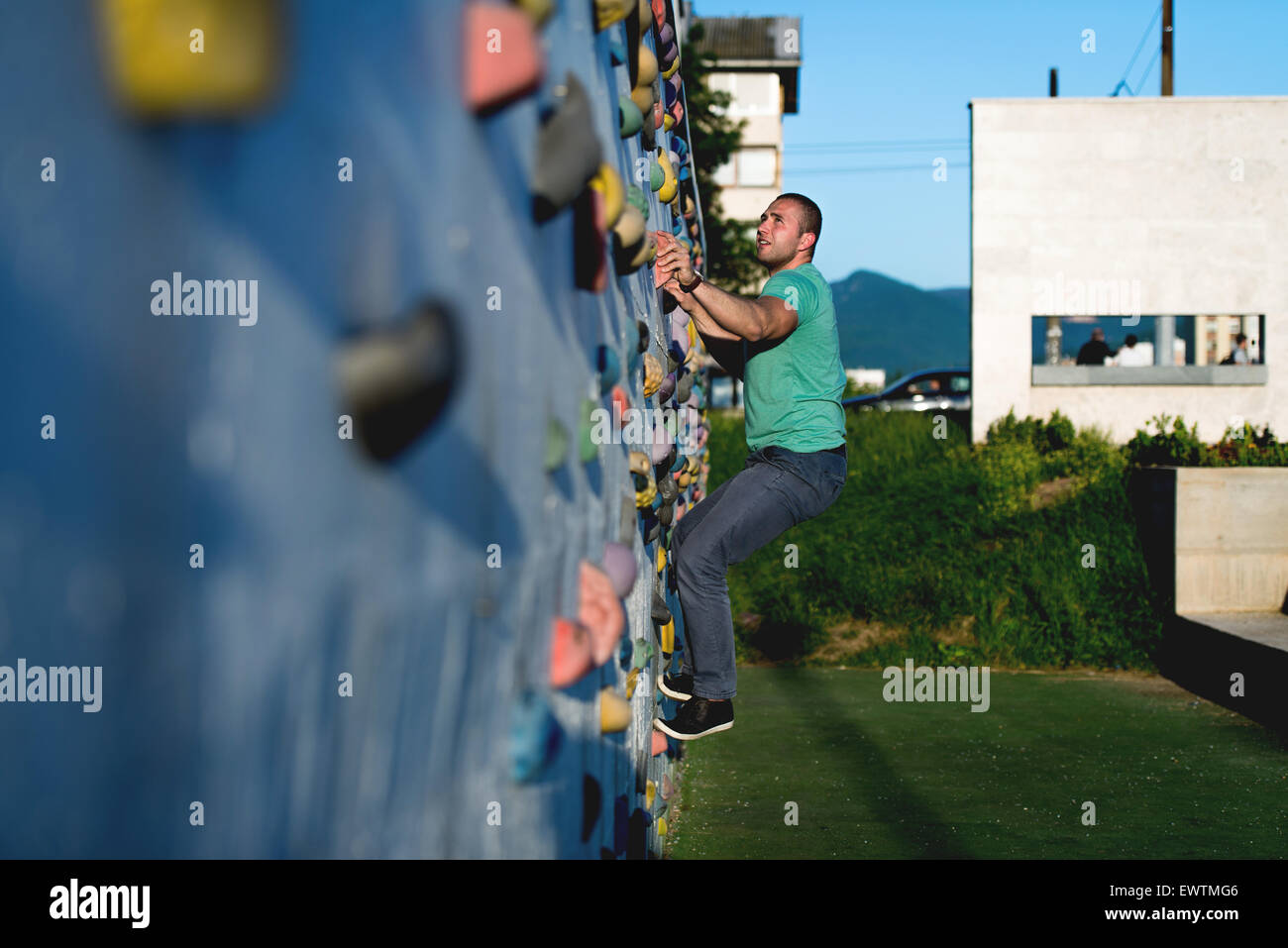young man climbing wall rock outdoors Stock Photo - Alamy