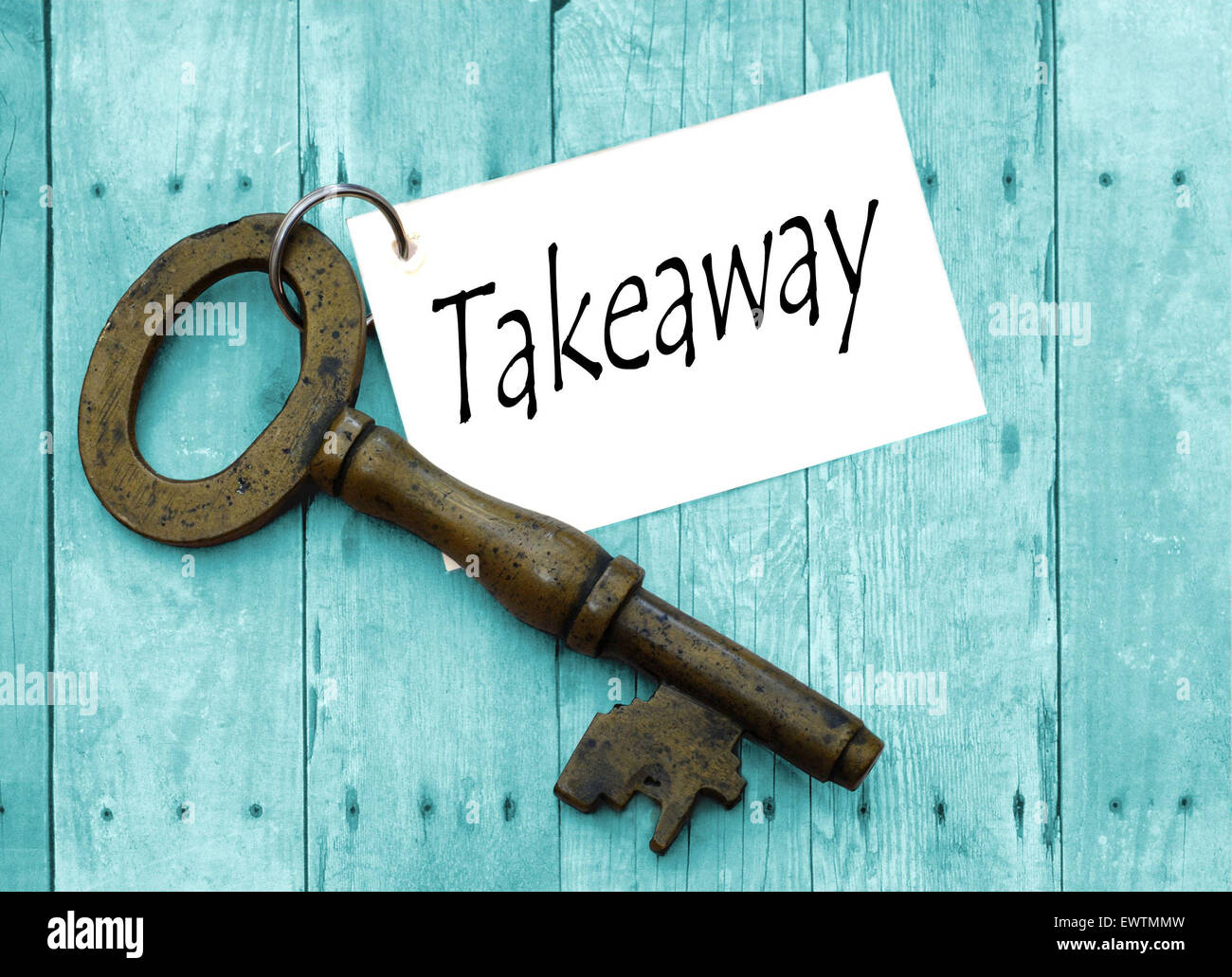 An antique key tagged with the word takeaway on rustic cyan background Stock Photo