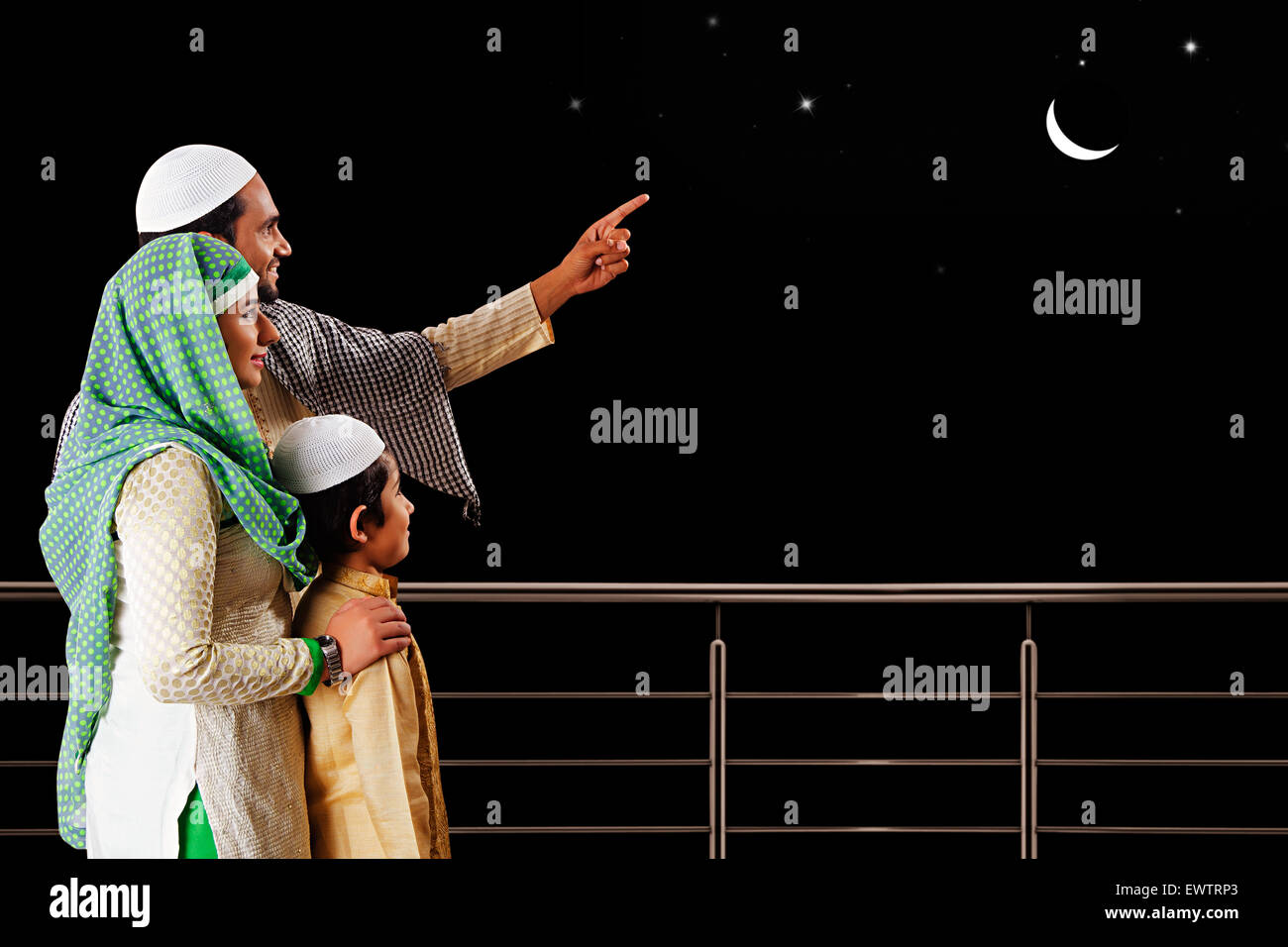 indian Muslim Parents and son showing moon Stock Photo